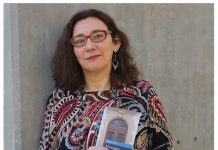 Marta Mori: «La lliteratura asturiana tien que dexar de mirase l’ombligu» L'autora suxetando ún de los sos llibros. Fondu neutru.